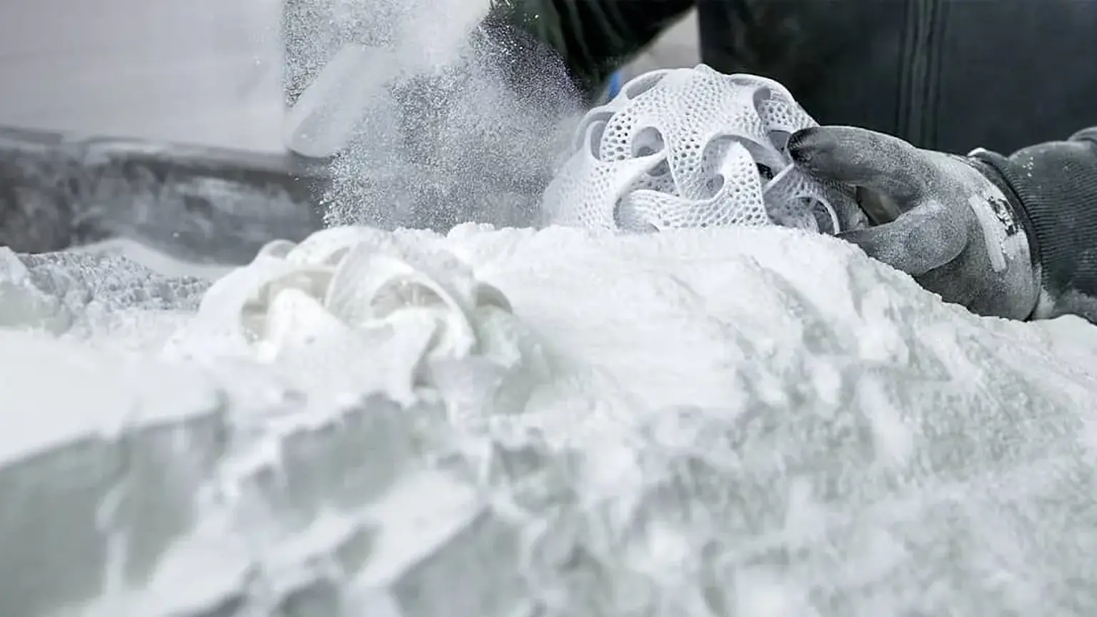 Nylon SLS lattice part being lifted out of unfused powder